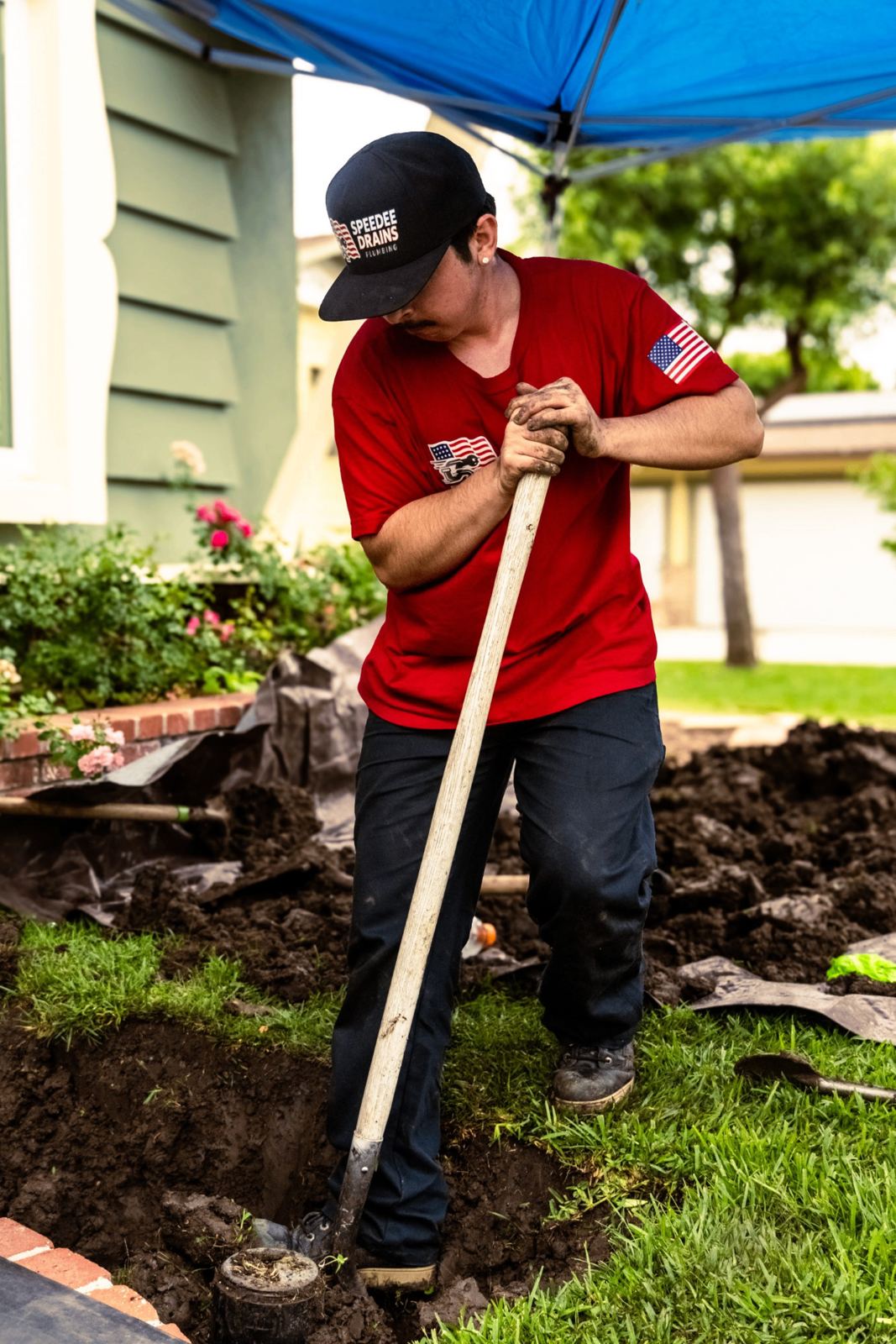 SpeeDee Drains plumber hand-digging to expose a broken cleanout for repair in Orange County, CA