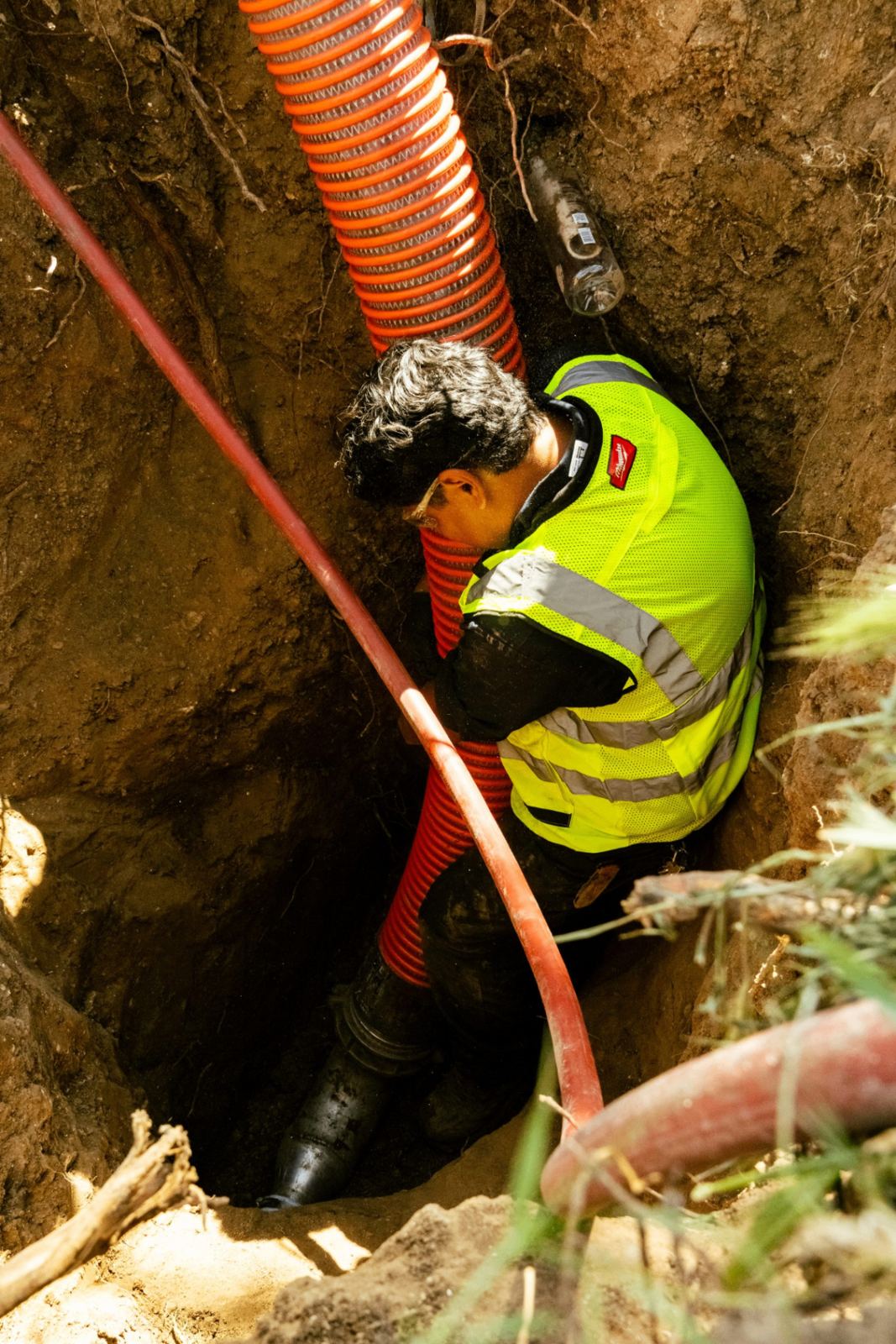 SpeeDee Drains technician installing new sewer piping inside a trench in Orange County, CA