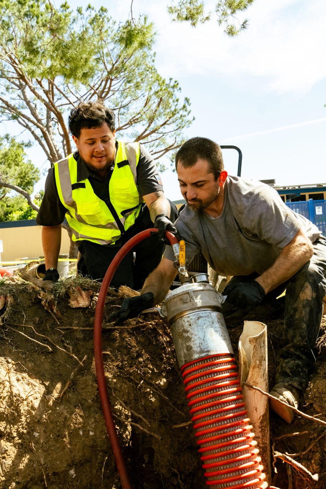 SpeeDee Drains crew cutting invasive tree roots out of a sewer line with a hydraulic cutter in Orange County, CA