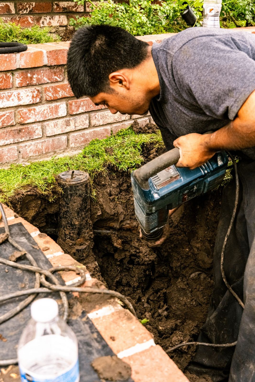 SpeeDee technician using a rotary drain machine to clear a sewer cleanout in Fullerton, CA