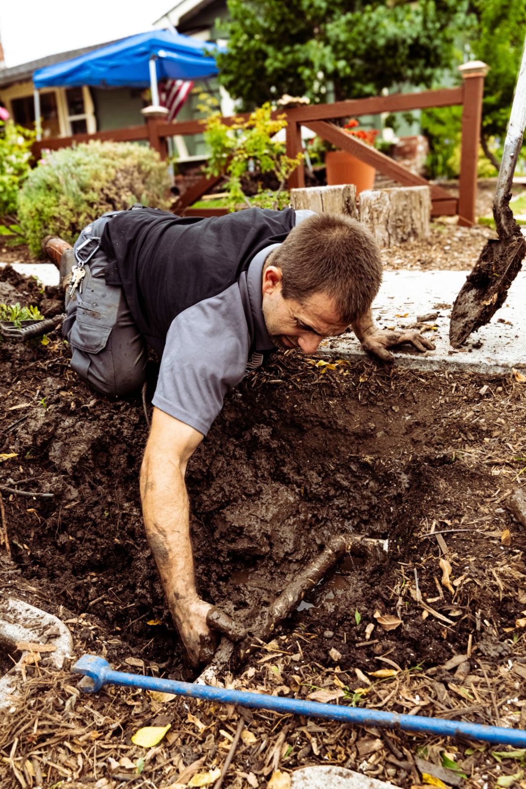 SpeeDee plumber hand-excavating a broken drain line for spot repair in Orange County, CA