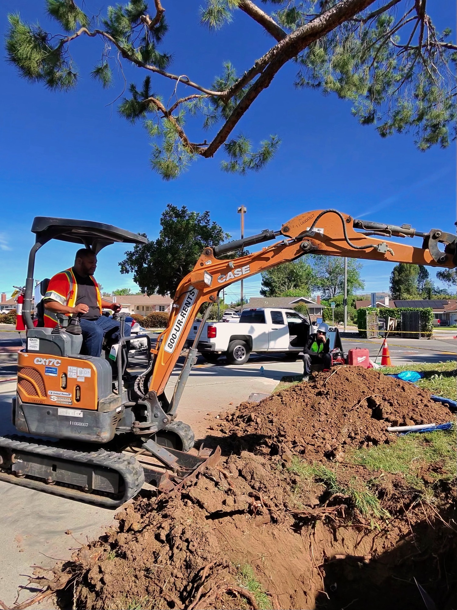 Mini excavator trenching a job site