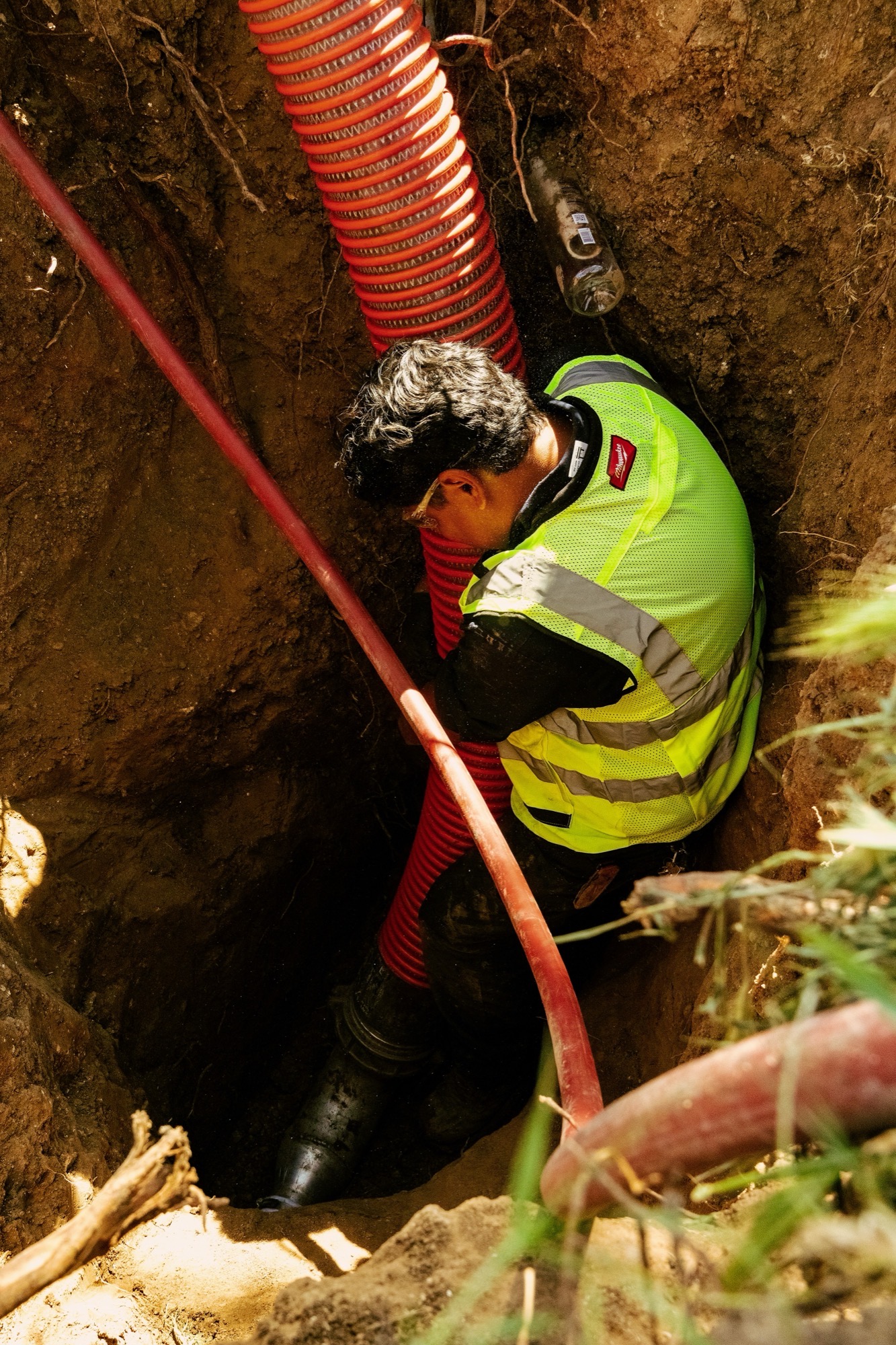 Speedee Drains technicians discussing a job on-site